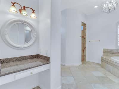 Dedicated vanity area with granite countertops, decorative mirror, upgraded lighting, and easy access to the luxurious primary bath. Thoughtfully designed for everyday comfort in this beautiful Glendale residence.