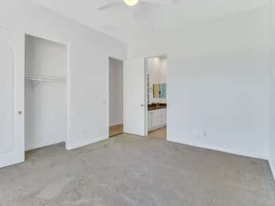 Spacious bedroom offering soft carpeting, neutral d cor, ceiling fan, generous closet storage, and a bright, welcoming atmosphere within this beautifully maintained Glendale property.