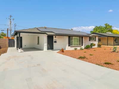 Covered front entry and spacious carport create a welcoming first impression while offering convenient protected parking. This updated Phoenix rental combines modern improvements with classic ranch-style charm.