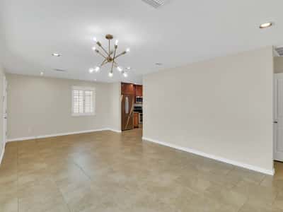 Expansive open interior featuring seamless transitions between the living room and kitchen, creating an inviting environment for entertaining and everyday living in this beautifully updated Phoenix rental.