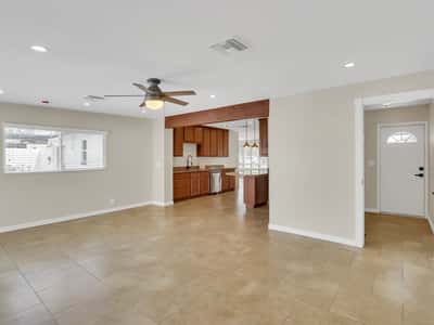 Spacious family room with oversized windows, modern finishes, and an open floor plan that flows effortlessly into the kitchen. This remodeled Phoenix rental is designed for comfortable everyday living.