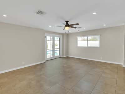 Bright family room with French doors leading to the private backyard and resurfaced pool, creating a seamless indoor-outdoor lifestyle. Enjoy comfortable living in this updated Phoenix rental.