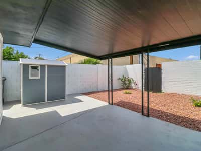 Relax beneath the covered patio while enjoying the low-maintenance backyard with decorative landscaping, storage shed, and private outdoor space. An ideal extension of this beautifully updated Phoenix rental, complete with a resurfaced pool for year-round enjoyment.