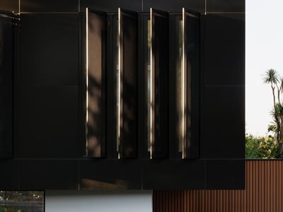Contemporary architectural design featuring sleek black panels, offering a modern aesthetic and inviting outdoor space.