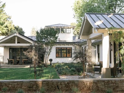 Charming modern home with stylish architecture, lush landscaping, and inviting outdoor spaces perfect for entertaining.