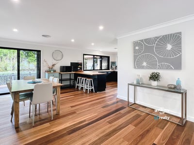 Spacious open-plan living area with modern finishes, large windows, and abundant natural light throughout.