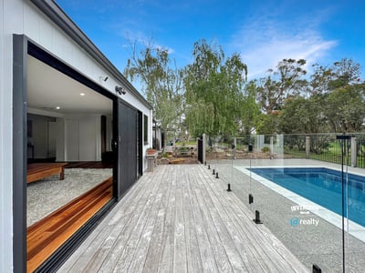 Modern home featuring open spaces, seamless indoor-outdoor flow, and a refreshing pool set amidst nature.
