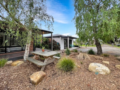Discover a unique outdoor space featuring a picnic area surrounded by natural landscaping and modern amenities.
