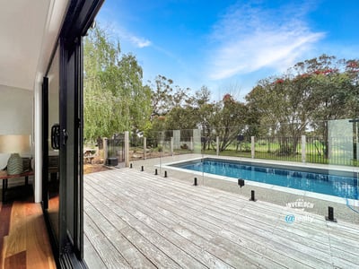 Spacious indoor-outdoor living with modern pool views, surrounded by lush greenery and serene landscapes.