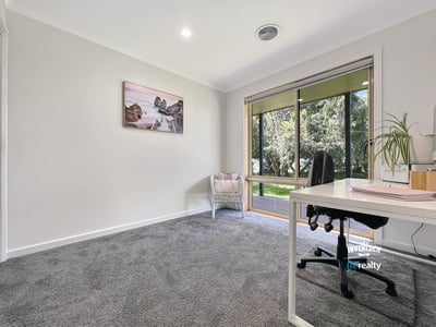 Bright and spacious room with large windows, offering peaceful views and ample natural light for productivity.
