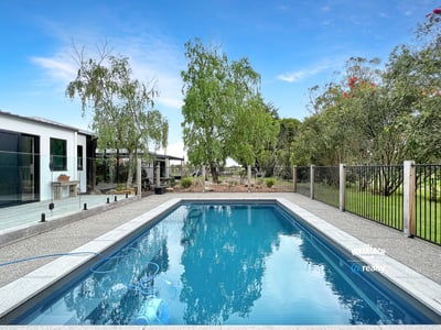 This property features a refreshing pool and landscaped yard, perfect for outdoor gatherings and relaxation.