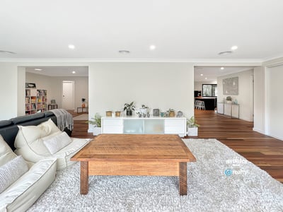 Spacious living area with modern design, featuring abundant light and seamless flow to adjacent rooms.