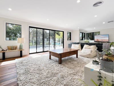 Spacious living area featuring large windows, modern furnishings, and seamless indoor-outdoor flow for relaxation and entertainment.