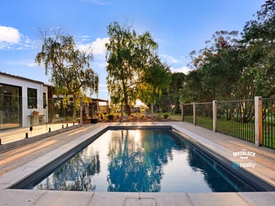 Discover this inviting outdoor space featuring a refreshing pool, surrounded by lush greenery and modern amenities.