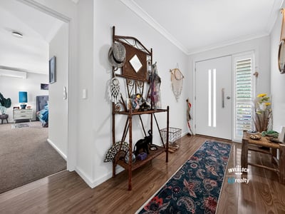 Bright and inviting entrance features unique decor, leading to spacious living areas filled with natural light.