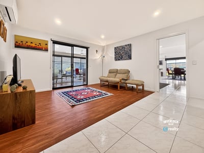 Spacious living area seamlessly connects to a bright, inviting outdoor space perfect for gatherings.