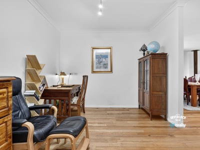Bright, open workspace features natural light, wooden flooring, and functional design for productivity and comfort.