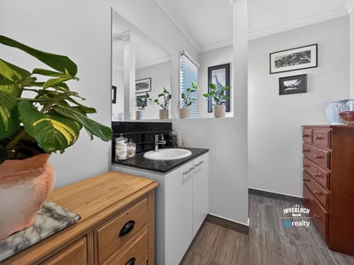 Bright bathroom featuring modern fixtures, ample storage, and abundant natural light from large windows.