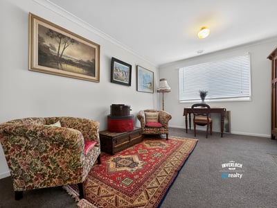 Bright and inviting living area featuring vintage decor, warm textiles, and ample natural light.