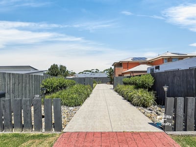 Welcoming pathway leads to a well-maintained outdoor space, perfect for relaxation and gatherings.