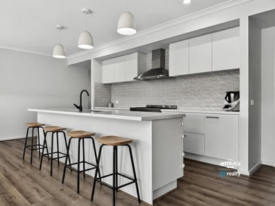 Modern kitchen featuring sleek cabinetry, ample counter space, and a spacious island perfect for gatherings.