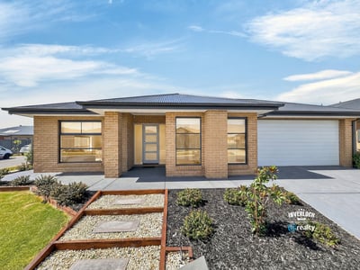 Spacious single-level home featuring modern architecture and easy-maintenance landscaping, set in a desirable neighborhood.