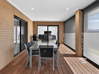 Spacious outdoor dining area with modern finishes, perfect for entertaining or relaxing in comfort.
