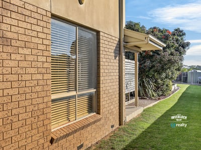 Spacious outdoor area with well-maintained landscaping and ample natural light streaming through large windows.