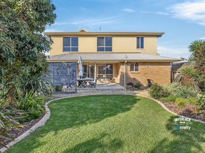 This spacious two-story home features a landscaped yard, perfect for outdoor gatherings and relaxation.