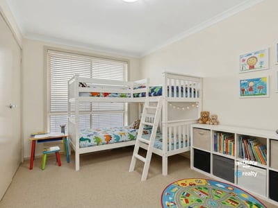 Bright and inviting children's room featuring a bunk bed, playful decor, and ample storage options.