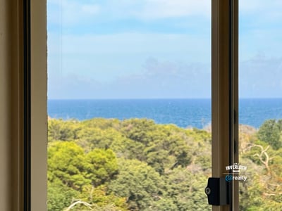 Enjoy breathtaking ocean views and lush greenery from this beautifully positioned window in your new home.