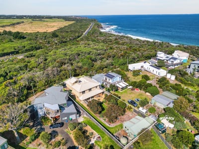 Coastal property featuring stunning ocean views, lush greenery, and easy access to scenic beachfront.