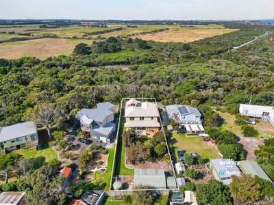This spacious property features a large yard, surrounded by lush greenery and stunning natural vistas.