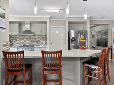 Modern kitchen featuring sleek appliances, a spacious island, and ample natural light for cooking and entertaining.