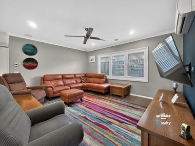Spacious living area features contemporary furnishings and vibrant decor, perfect for relaxation and entertaining.