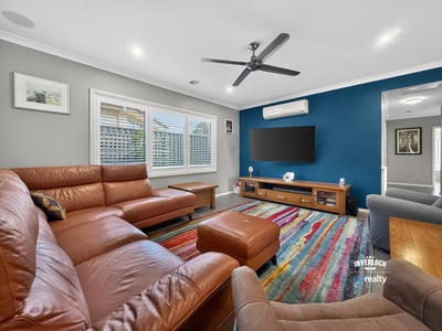 Spacious living area featuring modern furnishings, vibrant colors, and ample natural light for comfortable gatherings.