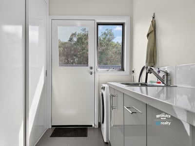 Bright and functional laundry area with modern appliances and natural light, perfect for everyday tasks.