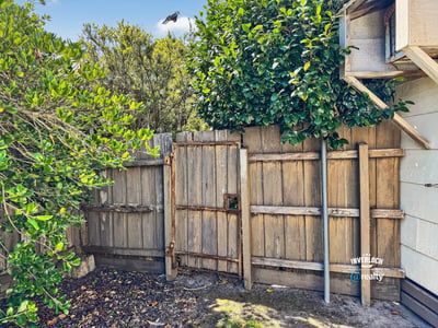 Discover a unique outdoor space featuring rustic fencing and natural greenery, perfect for private relaxation.
