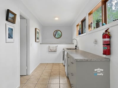 Bright and functional laundry space featuring natural light, ample counter space, and modern cabinetry.