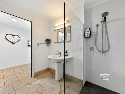 Modern bathroom featuring a spacious shower, contemporary fixtures, and a neutral color palette for a fresh feel.