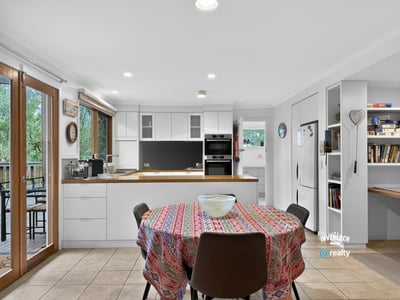 Bright, open kitchen with modern appliances and a spacious dining area, perfect for gatherings.