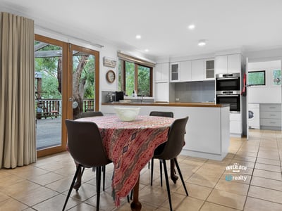 Spacious kitchen with modern appliances and direct access to an outdoor deck, perfect for entertaining.
