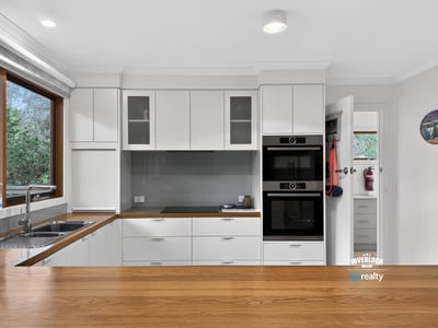 Modern kitchen with sleek cabinetry, high-quality appliances, and ample natural light creating an inviting atmosphere.
