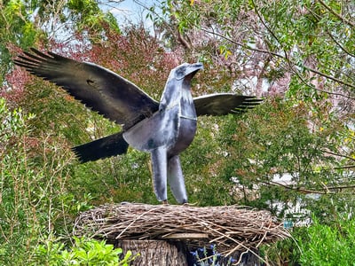 This property features a unique metal sculpture of a bird, adding artistic flair to the lush surroundings.