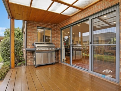 Enjoy outdoor entertaining on this spacious deck, featuring dual BBQs and easy access to the interior.