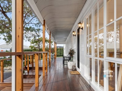 Discover this inviting porch offering a perfect blend of outdoor relaxation and easy access to the home.
