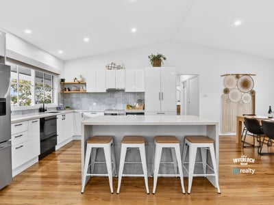 Bright, open kitchen with modern appliances, spacious island, and inviting dining area for entertaining.
