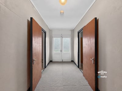 Spacious entrance featuring double doors, leading to sunlit rooms and versatile layout opportunities.