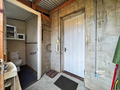 Functional entryway featuring a convenient bathroom and access to additional storage options.