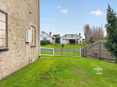 This property offers a spacious side yard with easy access to the street and neighboring homes.